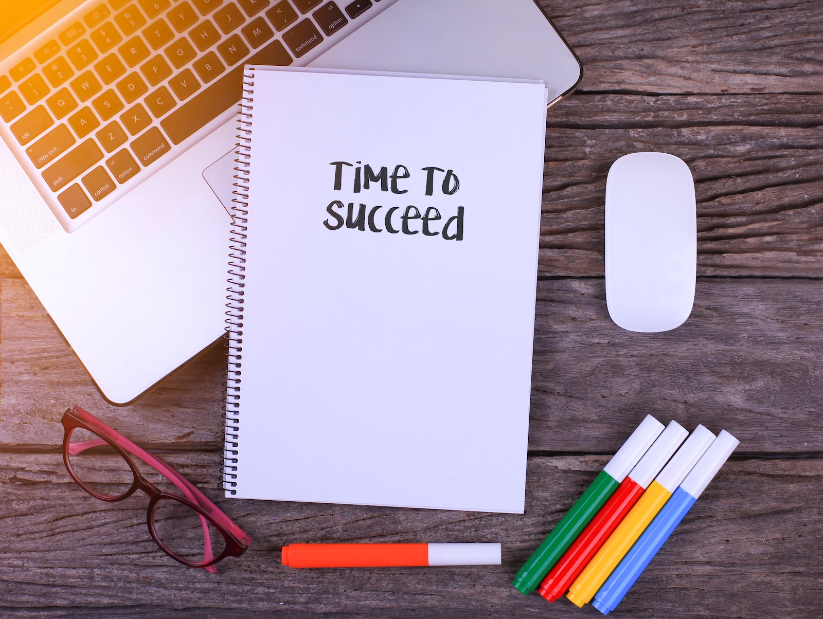 Notebook writing Time To Succeed, Office table with laptop ,coffee cup,glasses